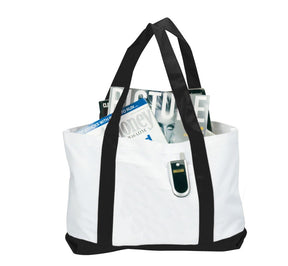 White tote bag with black handles holding magazines on a white background